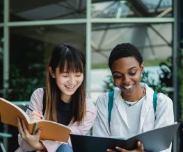 Tutor providing academic support and tracking student progress at school